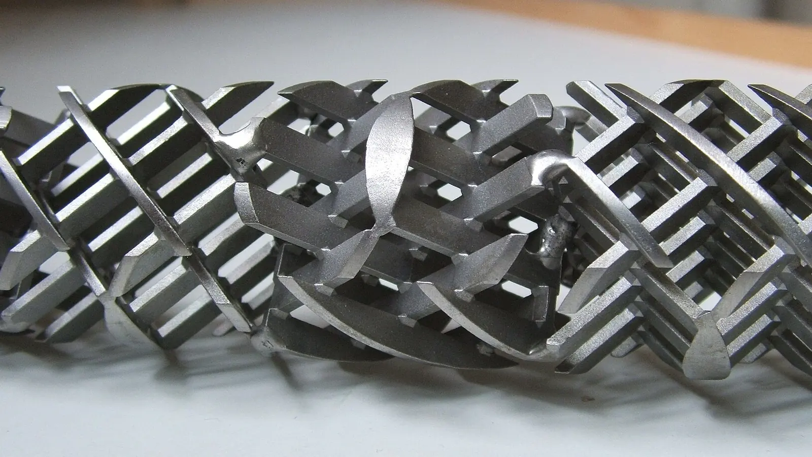 Static mixer application: stainless helical Kenics-type mixing element on white