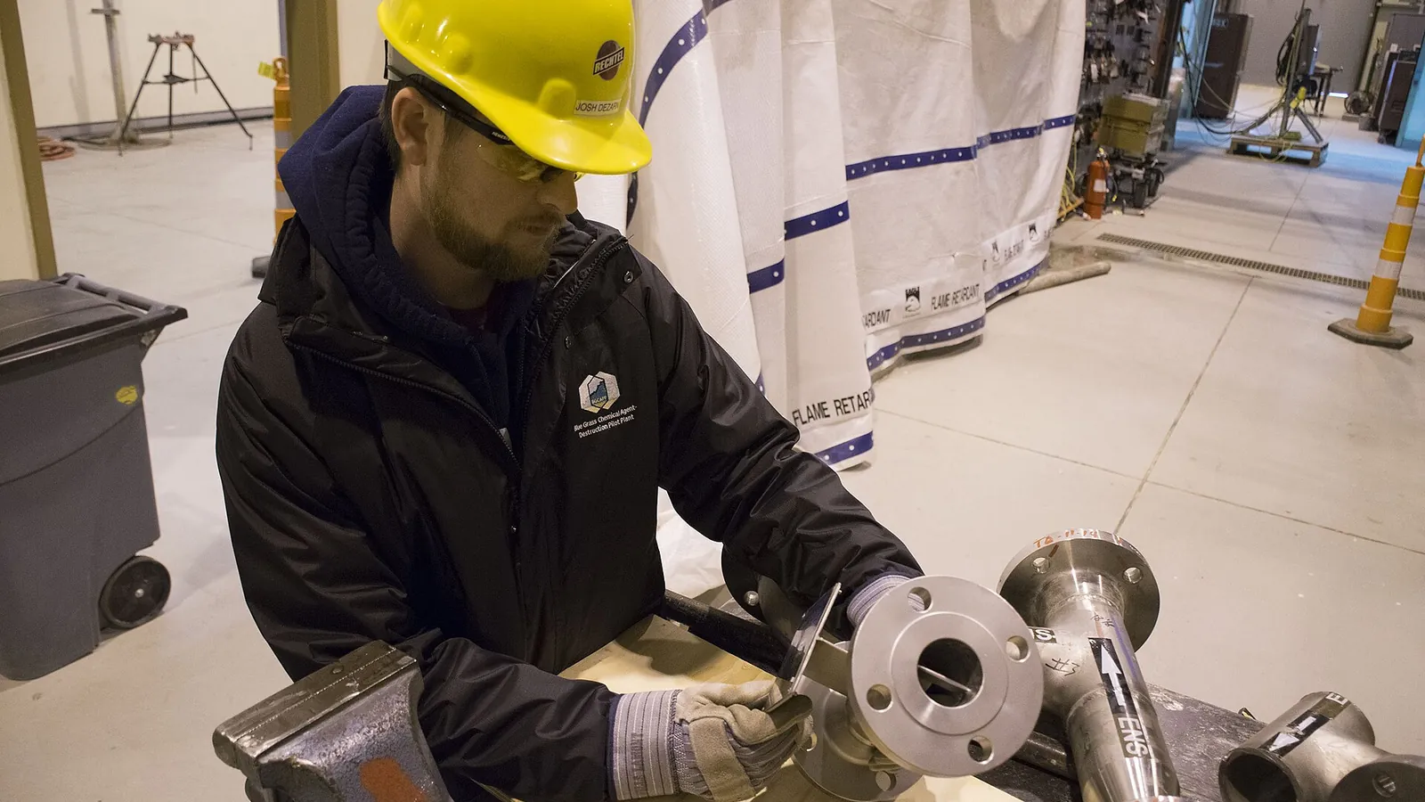 Static mixer application: worker assembling flanged pipe fittings