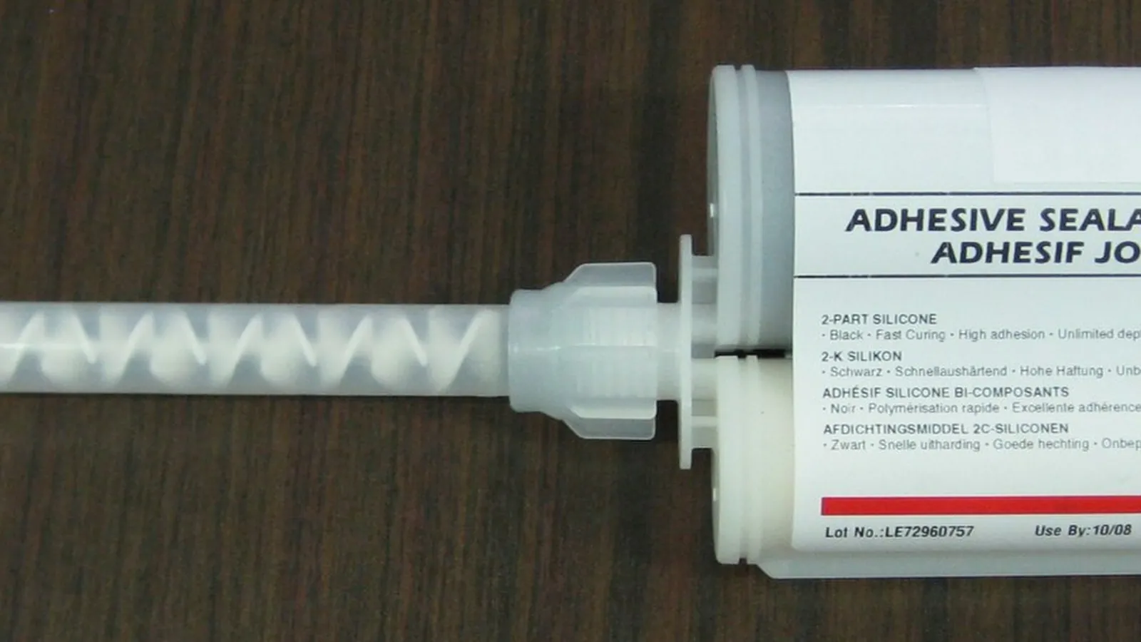 Static mixer application: two-component cartridge with static mixer nozzle on wood table